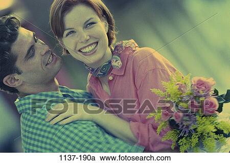 people, smiling, happy, holding, flowers, couples outdoors, hugging View Large Photo Image Stock Image - people, smiling, happy, holding, flowers, couples outdoors, hugging. Fotosearch