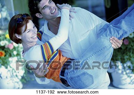people, smiling, happy, sunglasses, couples outdoors, hugging, carrying View Large Photo Image Stock Image - people, smiling, happy, sunglasses, couples outdoors, hugging, carrying. Fotosearch