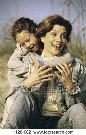 Stock Image - people, smiling, mother, laughing, outdoors, hugging, smile. Fotosearch
