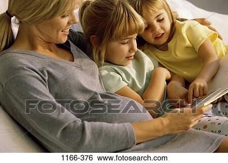 people, smiling, mother, reading, bed, pointing View Large Photo Image Stock Photograph - people, smiling, mother, reading, bed, pointing. Fotosearch