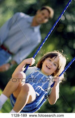 people, smiling, playing, laughing, swing, playful, outdoors View Large Photo Image Stock Photo - people, smiling, playing, laughing, swing, playful, outdoors. Fotosearch