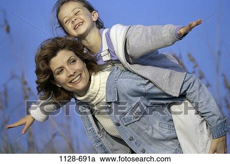 people, smiling, playing, mother, outdoors, jackets View Large Photo Image Stock Image - people, smiling, playing, mother, outdoors, jackets. Fotosearch