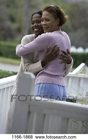 Stock Photo - people, smiling, railing, mother, walkway, trees, outdoors. Fotosearch