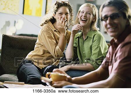 Stock Image - people, smiling, sitting, laughing, friends, smile. Fotosearch