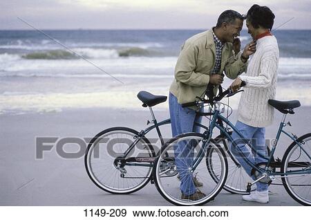 people, smiling, staring, couple, beach, sports View Large Photo Image Stock Photo - people, smiling, staring, couple, beach, sports. Fotosearch
