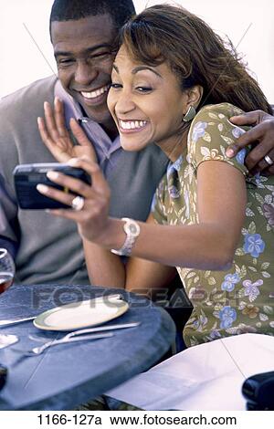 people, smiling, table, couple, plate, watch, outdoors View Large Photo Image Stock Image - people, smiling, table, couple, plate, watch, outdoors. Fotosearch