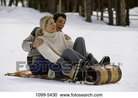 people, snow, couple, winter, laughing, riding, sliding View Large Photo Image Stock Image - people, snow, couple, winter, laughing, riding, sliding. Fotosearch