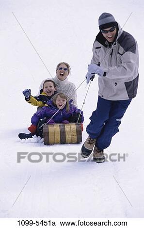 people, snow, winter, outdoors, pulling, family, sledding View Large Photo Image Stock Image - people, snow, winter, outdoors, pulling, family, sledding. Fotosearch