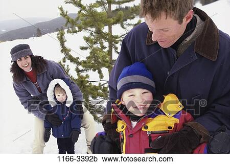 people, snow, winter, playful, outdoors, family, coats View Large Photo Image Stock Image - people, snow, winter, playful, outdoors, family, coats. Fotosearch