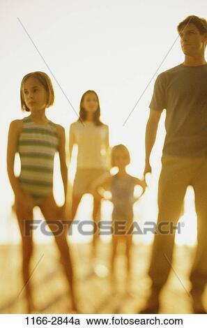 Stock Image - people, standing, outdoors, individuality, family, stand, waiting. Fotosearch