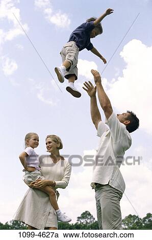 people, summer, outdoors, outings, family, tossing, toss View Large Photo Image Stock Image - people, summer, outdoors, outings, family, tossing, toss. Fotosearch