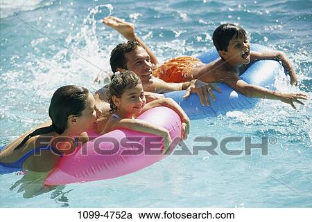 Stock Image - people, swim, floating, water, pool, playing, swimming. Fotosearch