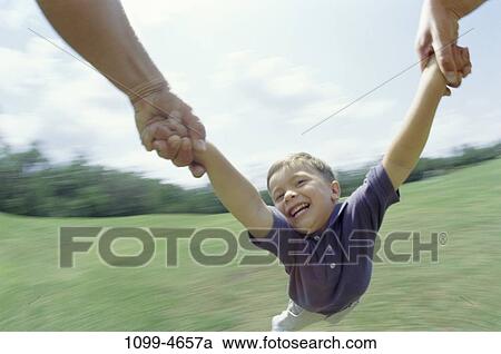Stock Image - people, swinging, swing, boy, outdoors, speed, strength. Fotosearch