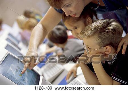 Stock Photo - people, teacher, technology, classroom, pointing, point, computers. Fotosearch