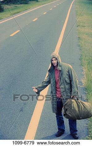 people, thumb, coat, road, standing, outdoors View Large Photo Image Stock Photo - people, thumb, coat, road, standing, outdoors. Fotosearch