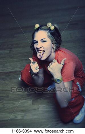 Picture - people, tongue, gesturing, individuality, freedom, mischievous, piercing. Fotosearch