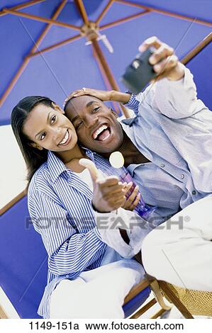 people, umbrella, couple, beach, playful, lifestyles, outdoors View Large Photo Image Stock Image - people, umbrella, couple, beach, playful, lifestyles, outdoors. Fotosearch