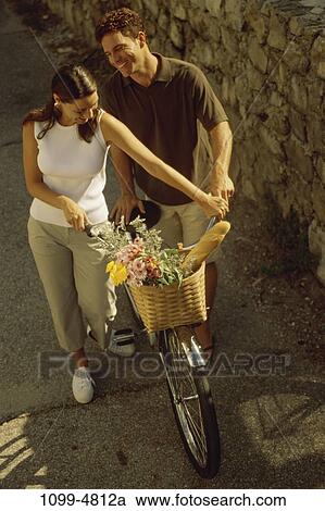 people, walking, couple, bicycle, flowers, basket, wheel View Large Photo Image Stock Image - people, walking, couple, bicycle, flowers, basket, wheel. Fotosearch