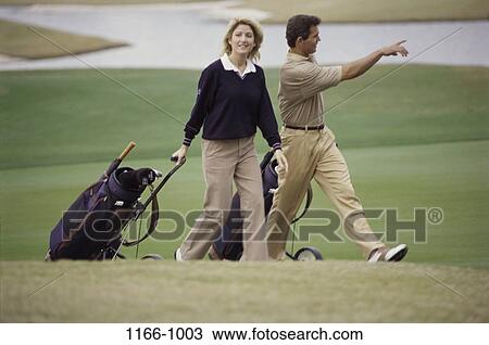 people, walking, golf, couple, outdoors, sports View Large Photo Image Stock Image - people, walking, golf, couple, outdoors, sports. Fotosearch