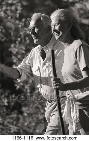 Stock Photograph - people, walking, gray, couple, active, senior, outdoors. Fotosearch