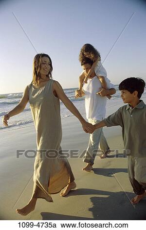 Stock Image - people, walking, Hispanic, beach, summer, outdoors, outings. Fotosearch