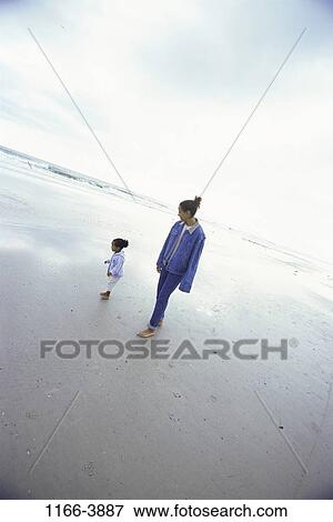 Stock Photo - people, walking, mother, beach, family, daughter, parent. Fotosearch