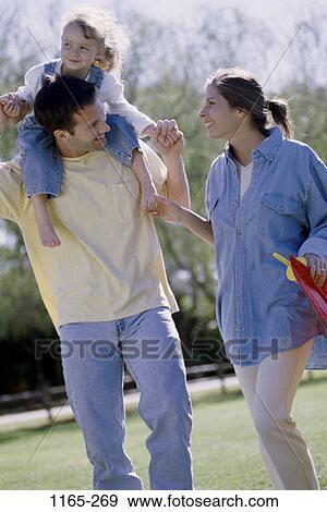 Stock Photo - people, walking, outdoors, park, tranquility, carrying, commitment. Fotosearch