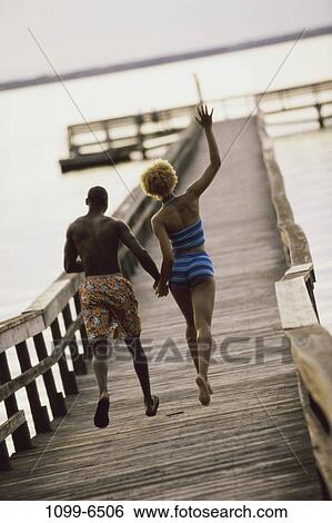 Stock Photograph - people, water, running, couple, lake, outdoors, dock. Fotosearch