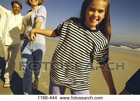people, water, smiling, walking, beach, holding, stripes View Large Photo Image Picture - people, water, smiling, walking, beach, holding, stripes. Fotosearch