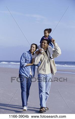 people, water, walking, beach, carrying, family, daughter View Large Photo Image Stock Image - people, water, walking, beach, carrying, family, daughter. Fotosearch