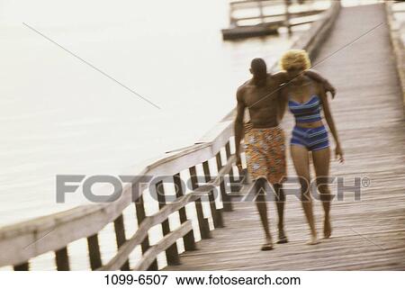 Stock Photo - people, water, walking, couple, outdoors, dock. Fotosearch