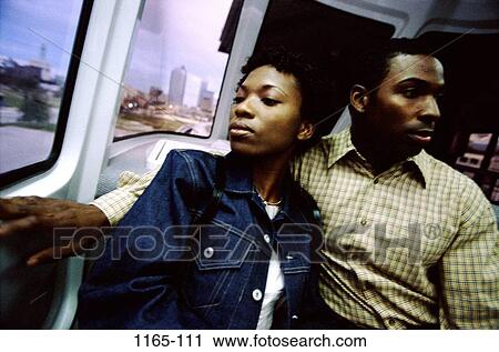 Stock Image - people, windows, buildings, road, couple, riding, train. Fotosearch