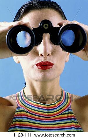 Stock Image - people, woman, binoculars, watch, watching, observing, brunette. Fotosearch