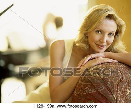 people, woman, couch, confident, Middle-aged, blond, indoors View Large Photo Image Stock Image - people, woman, couch, confident, Middle-aged, blond, indoors. Fotosearch