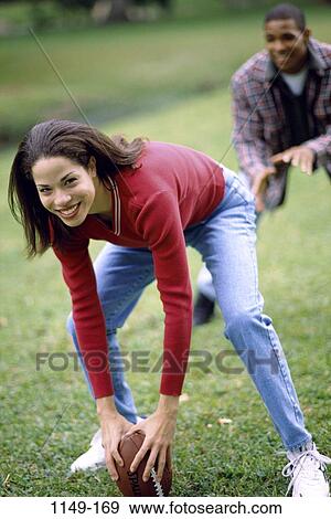 people, woman, couple, football, outdoors, sports, quarterback View Large Photo Image Stock Photo - people, woman, couple, football, outdoors, sports, quarterback. Fotosearch