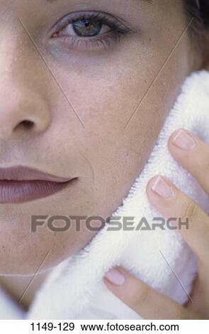 Stock Photo - people, woman, face, soft, towel, touching, beauty. Fotosearch