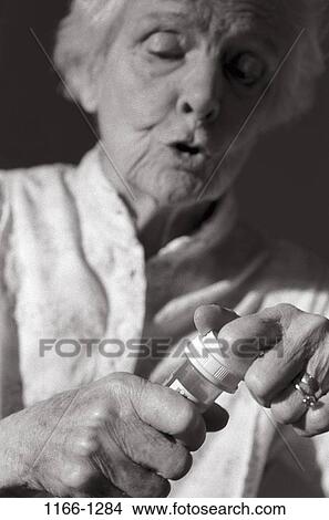 people, woman, gray, senior, bottle, open, prescription View Large Photo Image Picture - people, woman, gray, senior, bottle, open, prescription. Fotosearch
