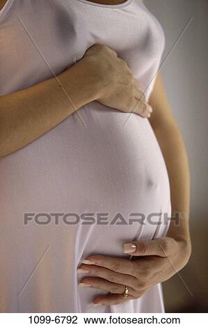 Stock Image - people, woman, holding, anticipation, touching, expectant, expecting. Fotosearch
