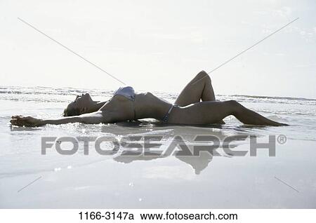 people, woman, ocean, beach, sunbathing, wet View Large Photo Image Stock Image - people, woman, ocean, beach, sunbathing, wet. Fotosearch