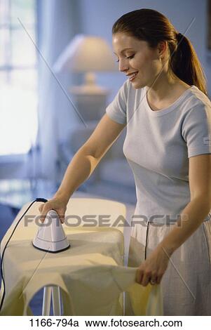 people, woman, shirt, standing, iron, stand, brunette View Large Photo Image Stock Image - people, woman, shirt, standing, iron, stand, brunette. Fotosearch