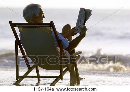 relaxed, people, relaxation, newspaper, eyeglasses, chair View Large Photo Image Stock Image - relaxed, people, relaxation, newspaper, eyeglasses, chair. Fotosearch