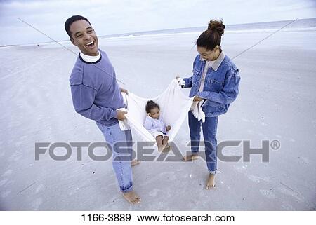 sand, people, beach, playful, carrying, family, daughter View Large Photo Image Stock Photo - sand, people, beach, playful, carrying, family, daughter. Fotosearch