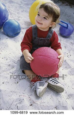 sand, people, playing, sitting, ball, toddler, holding View Large Photo Image Stock Photo - sand, people, playing, sitting, ball, toddler, holding. Fotosearch