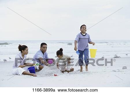 sand, people, water, playing, beach, family, digging View Large Photo Image Stock Image - sand, people, water, playing, beach, family, digging. Fotosearch