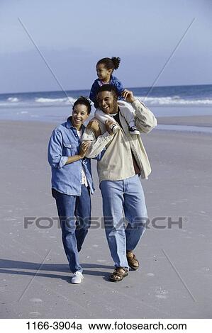 sand, people, water, walking, beach, carrying, family View Large Photo Image Stock Image - sand, people, water, walking, beach, carrying, family. Fotosearch