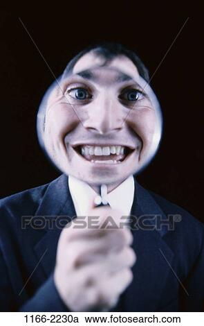 Stock Image - smiling, magnifying, face, business, contrast, Middle-aged. Fotosearch