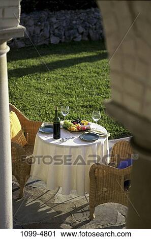 table, bottle, fruit, outdoors, chairs, stemware, plates View Large Photo Image Stock Image - table, bottle, fruit, outdoors, chairs, stemware, plates. Fotosearch