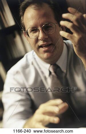 Stock Image - talking, eyeglasses, gesturing, business, Middle-aged, speaking. Fotosearch