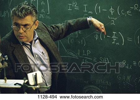 Picture - teacher, lifestyles, challenges, serious, education, blackboard, mathematics. Fotosearch