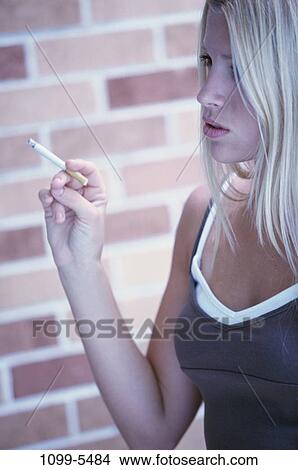 tobacco, people, smoke, cigarette, holding, outdoors, blond View Large Photo Image Picture - tobacco, people, smoke, cigarette, holding, outdoors, blond. Fotosearch